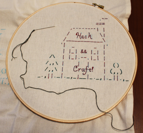 Hack & Crafts! logo: ascii art of a house, embroidered onto cloth